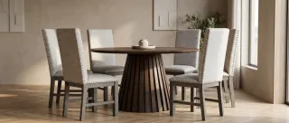 Round dining table with slatted pedestal and four upholstered dining chairs