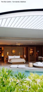 Luxury bedroom and poolside interior at a resort installation.