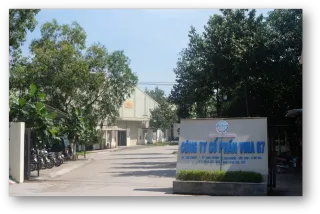Company premises and entrance sign on a tree-lined industrial street