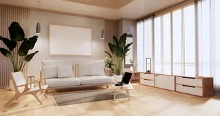 Bright living room with sofa, media cabinet, coffee table and armchair