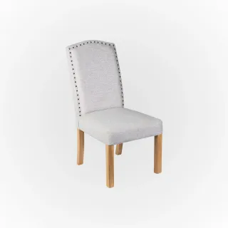 Light upholstered dining chair with nailhead trim and wooden legs