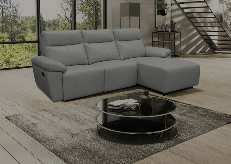 Gray sectional sofa with chaise and round coffee table in a bright living room