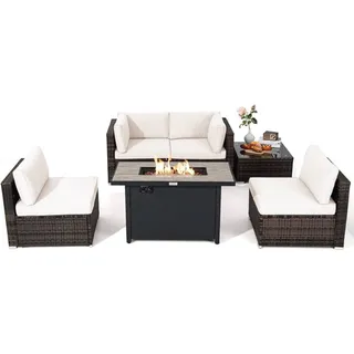 Outdoor wicker sofa and armchairs arranged around a rectangular fire table