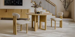 Wood dining table and upholstered chairs in a furnished dining room