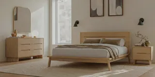 Wooden bed with matching dresser and bedside table in a bedroom