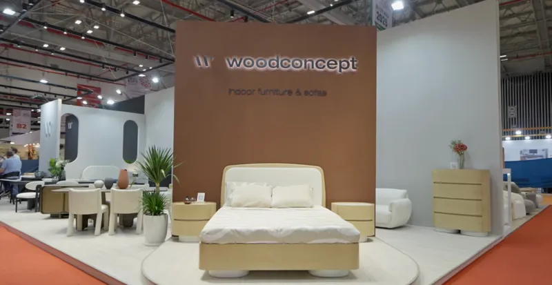 Wood Concept furniture exhibition stand displaying a bed, seating and storage furniture