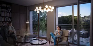 Living room with upholstered armchairs, coffee table and chandelier
