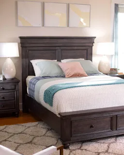 Dark wooden panel bed with footboard drawers and matching bedside table