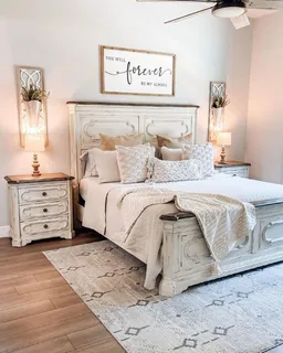 White distressed wooden bed with matching bedside chest and bedding